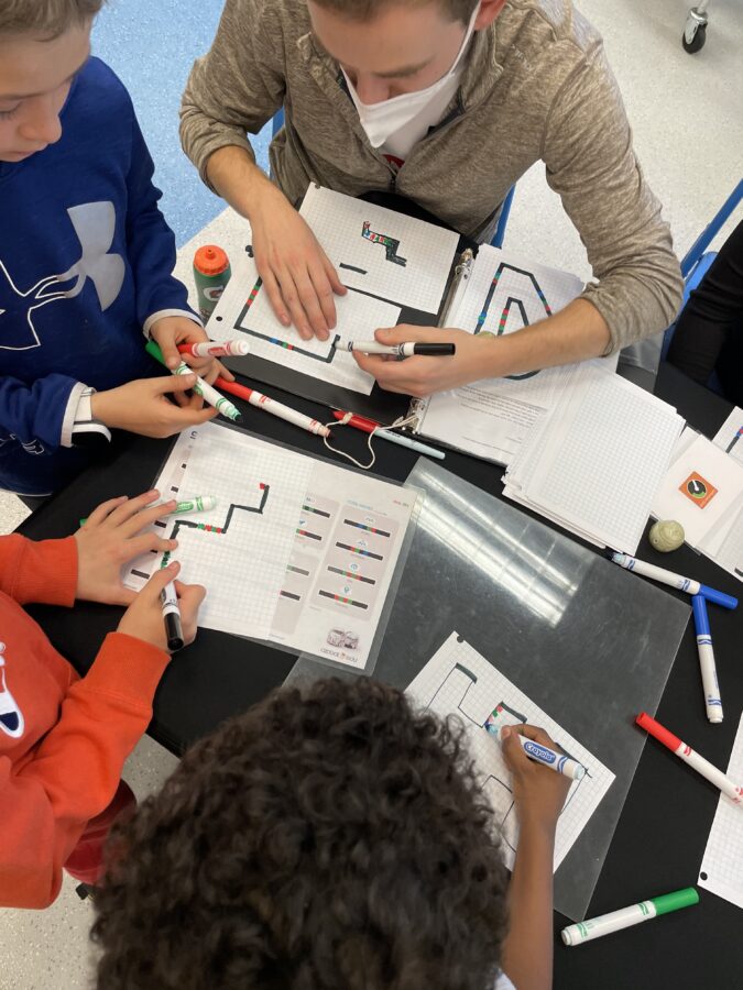 Students coding an Ozobot using color