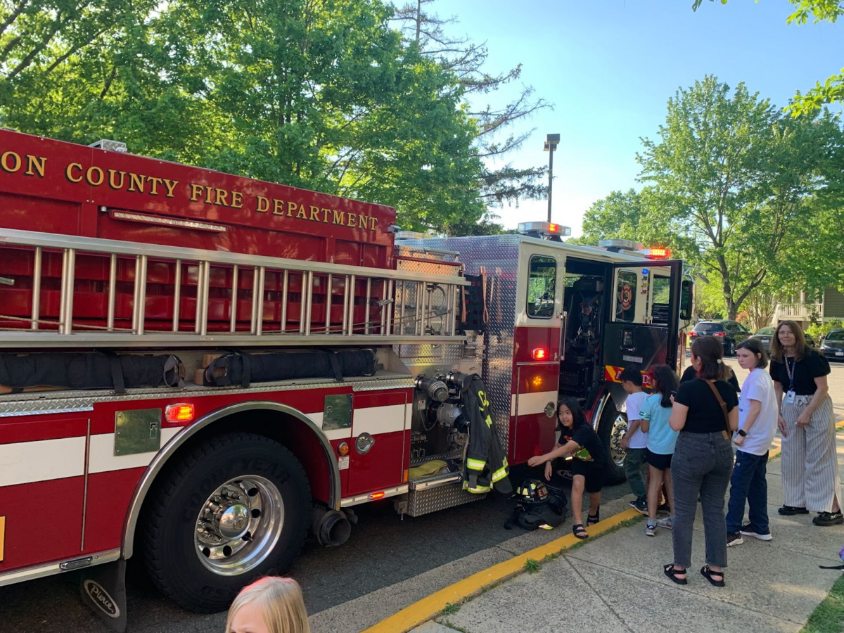 families standing outside a fire truck